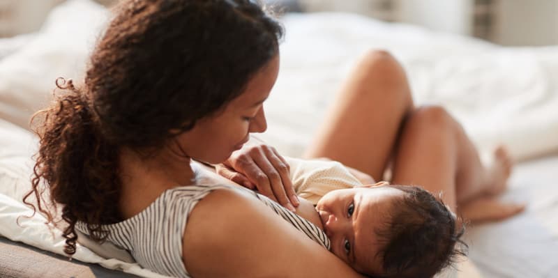 A mother breastfeeds her infant