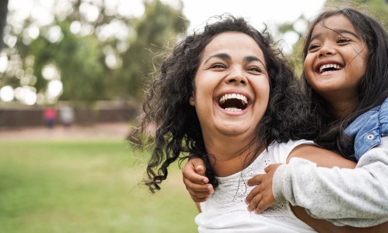 A south Asian mother and daughter, having a piggyback ride