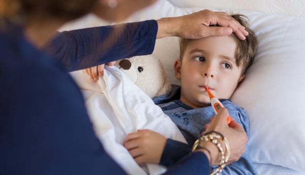 A mother takes her child's temperature